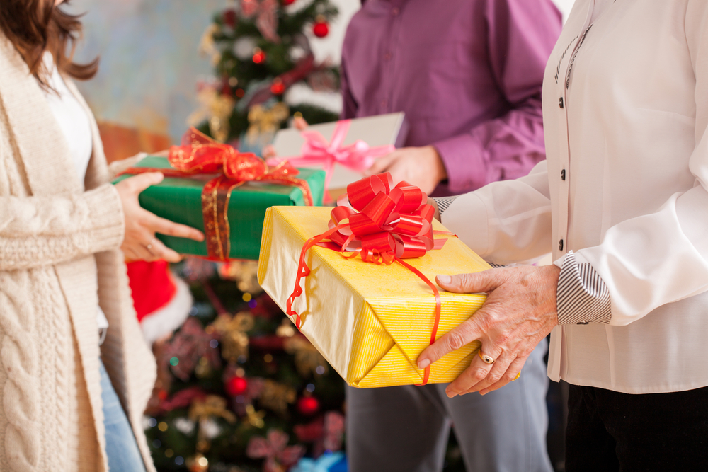 Happy family exchanging their Christmas gifts